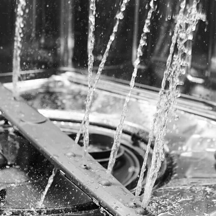 Close up on water spraying inside a dishwasher